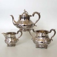 Lot 227 - Victorian three-piece silver tea set embossed