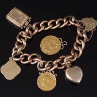 Lot 235 - Nine carat gold charm bracelet with half