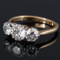 Lot 247 - Three-stoned diamond eighteen carat gold ring.