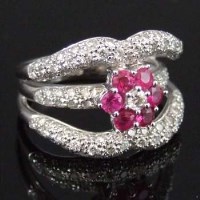 Lot 255 - Ruby and white gold triple band ring.