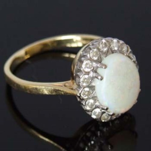 Lot 259 - 18ct gold opal and diamond oval cluster ring.