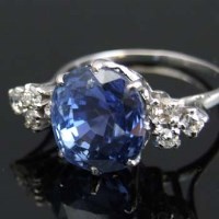Lot 295 - White gold sapphire and diamond cluster ring.