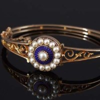 Lot 315 - Gold and pearl bangle