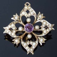 Lot 332 - Seed pearl and amethyst foliate 9ct gold brooch.