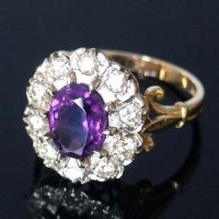 Lot 333 - 18ct gold amethyst and diamond oval cluster ring.
