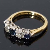 Lot 340 - Sapphire and diamond five-stone hoop ring in 18ct