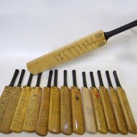 Lot 371 - Thirteen miniature cricket bats, all stamped with autographs of various teams, e.g. Australia/ England 1972, West Indies/ New Zealand 1973 etc and one