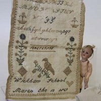 Lot 394 - Child's sampler and doll (2).