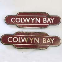 Lot 403 - Two Colwyn Bay station signs or totems, maroon and white, 36ins x 10ins, some discolouration and rusting. 2 items.