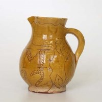 Lot 519 - West country slip ware jug dated 1792.
