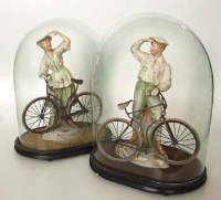 Lot 571 - Pair Gebruder Heubach slipcast figures with cycles