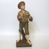 Lot 578 - Goldscheider figure of a boy reading.
