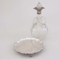 Lot 234 - Silver waiter and a silver necked decanter.