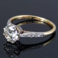 Lot 244 - 18 carat single stone diamond ring with six shoulder diamonds.
