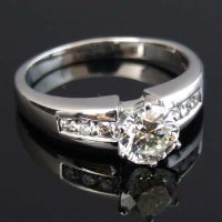 Lot 276 - Diamond ring, 1.04ct, on channel set shoulders in