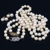 Lot 277 - Two cultured pearl necklaces with gold clasps ; a