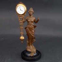 Lot 671 - Figural swinging clock by Junghans