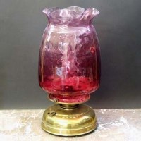 Lot 172 - Oil lamp with cranberry shade.