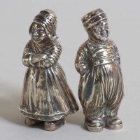 Lot 256 - Pair of silver Dutch boy and girl pepperettes