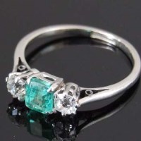 Lot 312 - 18ct gold emerald and diamond three-stone ring.