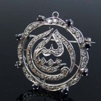 Lot 329 - Sapphire and diamond circular brooch.