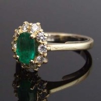 Lot 340 - Emerald and diamond cluster ring in 18ct yellow
