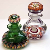 Lot 545 - Two paperweight bottles   set with colourful