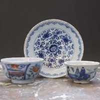 Lot 563 - Two Delft tea bowls and a saucer.