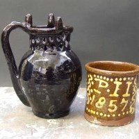 Lot 567 - 1857 Slip dated jar and puzzle jug.