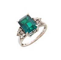 Lot 60 - Emerald single stone 18ct white gold ring with diamond set shoulders