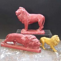 Lot 1081 - Two Minton majolica lions and one other.