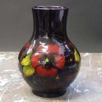 Lot 1089 - Moorcroft pansy pattern flambé vase.