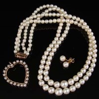 Lot 266 - Two strings of cultured pearls, a gold