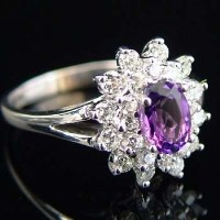 Lot 275 - Amethyst and diamond oval cluster ring, in white