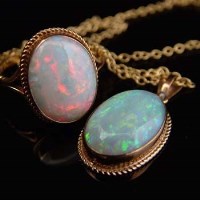 Lot 294 - Oval opal and gold ring and matching pendant
