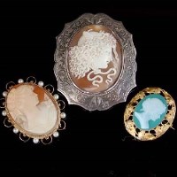 Lot 157 - Oval shell cameo in 9ct gold brooch mount, oval shell cameo cluster silver brooch mount 1893 and an oval shell cameo green in gold brooch mount.