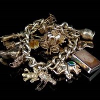 Lot 163 - Gold charm bracelet.