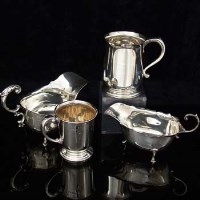 Lot 252 - Two silver sauce boats and two silver mugs