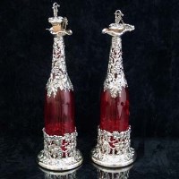 Lot 278 - Plated silver and cranberry glass decanters.
