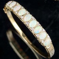 Lot 313 - 9ct gold opal and diamond bangle