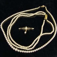 Lot 340 - Double string of cultured pearls with gold clasp