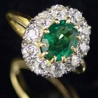 Lot 393 - 18ct emerald and diamond cluster ring
