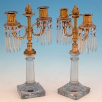 Lot 439 - Pair of brass and glass candelabra.