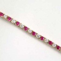 Lot 429 - Ruby and diamond yellow gold bracelet