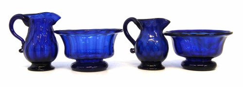 Lot 97 - Two blue glass jugs and bowls, with moulded