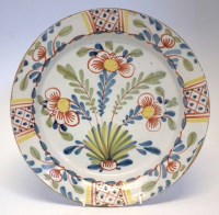 Lot 122 - Delft charger, boldly painted with three flowers