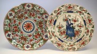 Lot 125 - Two Delft chargers, one painted with a lady sat