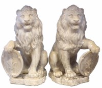 Lot 196 - Large pair of white pottery lions with shields.