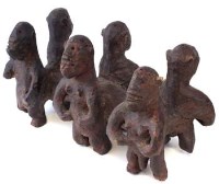 Lot 209 - Unusual figure group possibly Bari or Sukuma, carved as six figures standing beside a log, 54cm long.