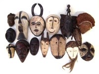 Lot 246 - Fifteen African masks carved in various tribal